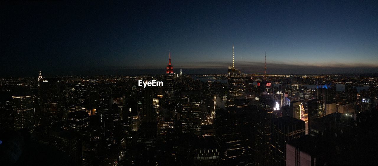 Aerial view of city lit up at night