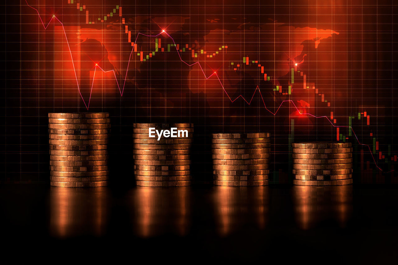 Stack of coins against digital graph