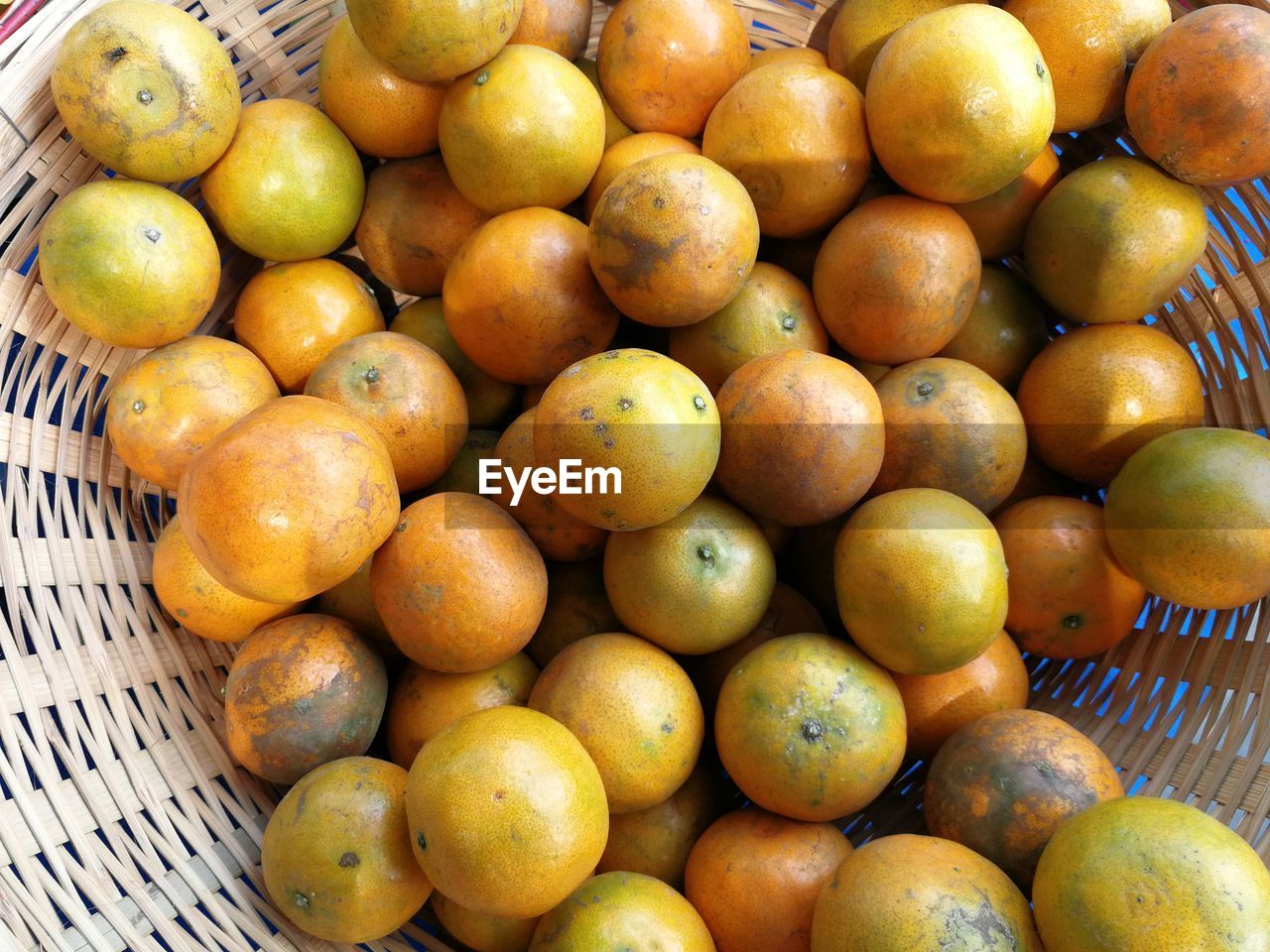 High angle view of oranges in basket at market stall