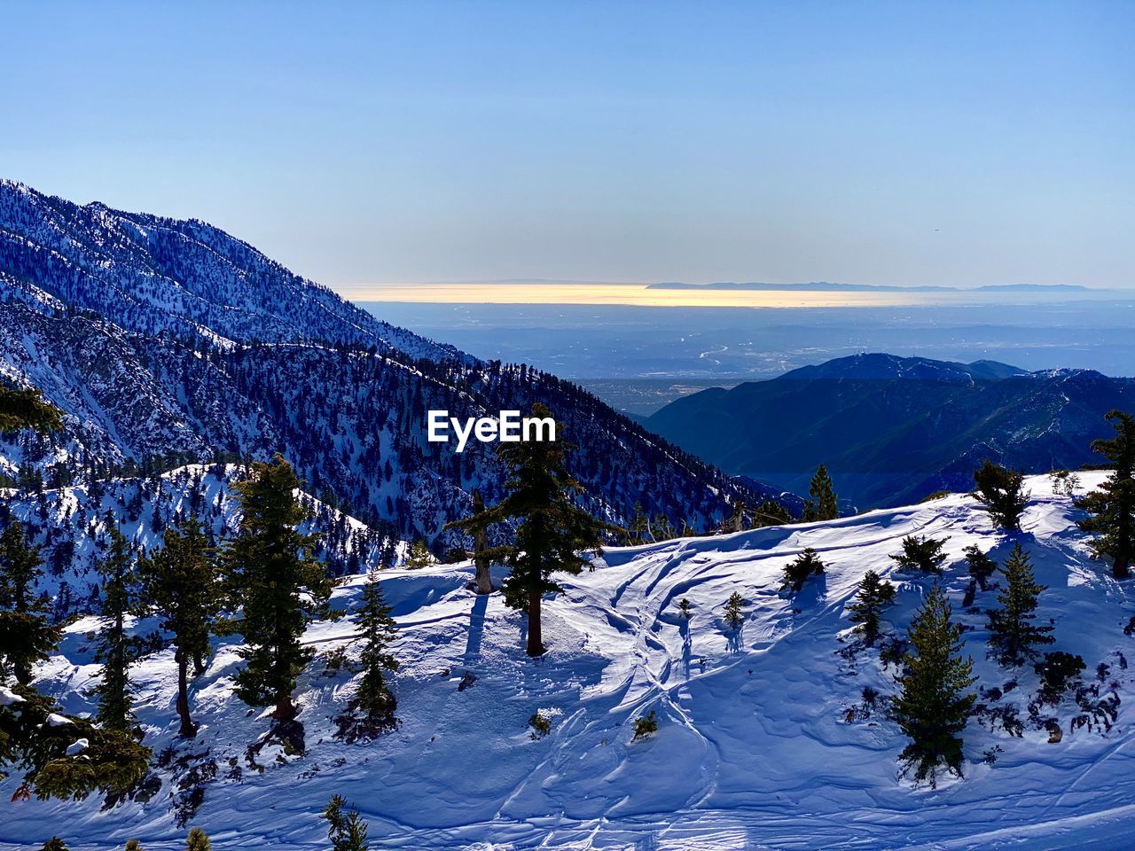 Scenic view of snowcapped mountains against sky during winter