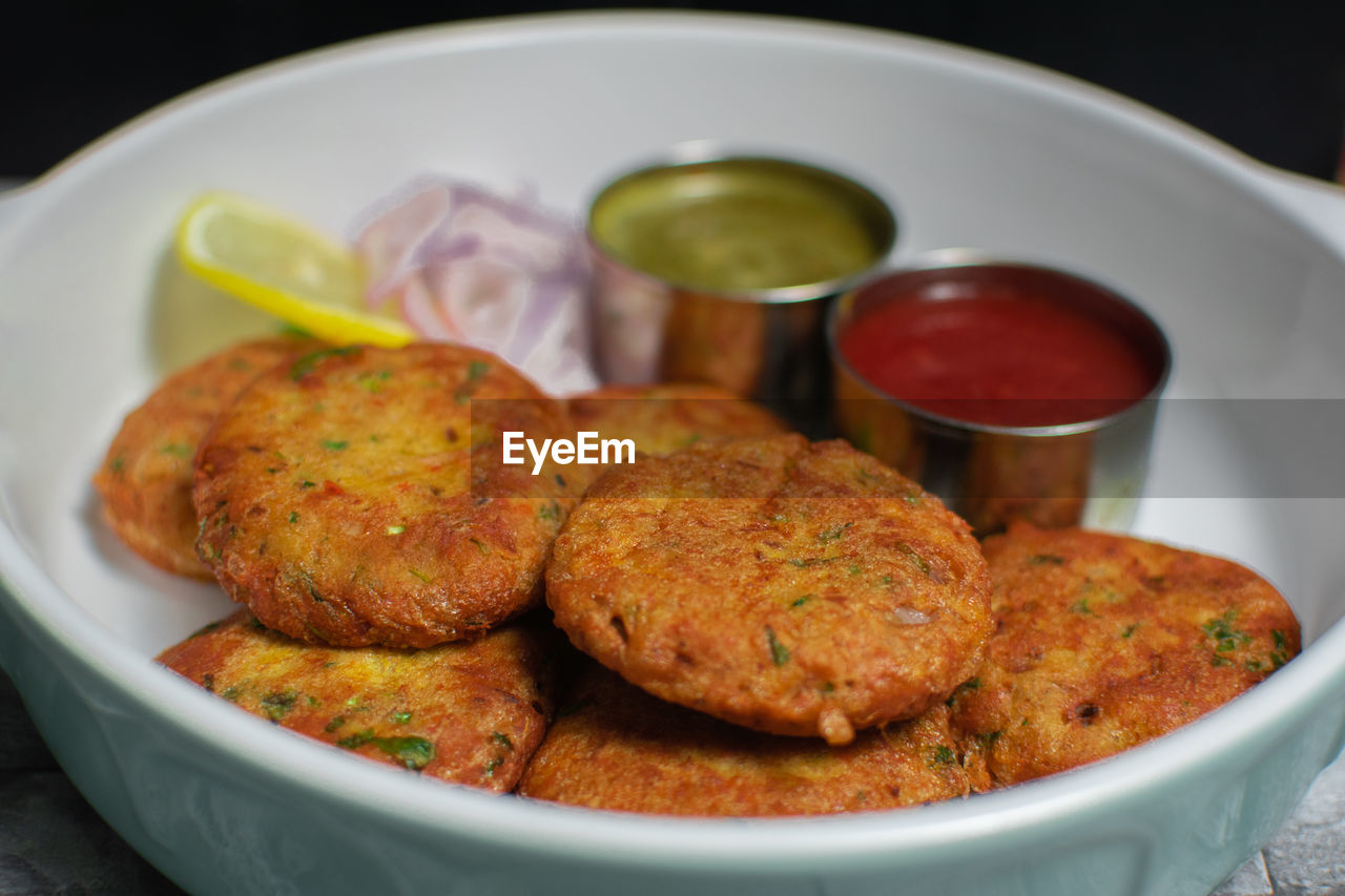 food and drink, food, fried food, fast food, fritter, dish, vegetarian food, no people, vegetable, fishcake, meat, plate, indian food, produce, cuisine, healthy eating, fried, condiment, freshness, meal, close-up, cutlet, savory food, sauce, indoors, asian food, meatball