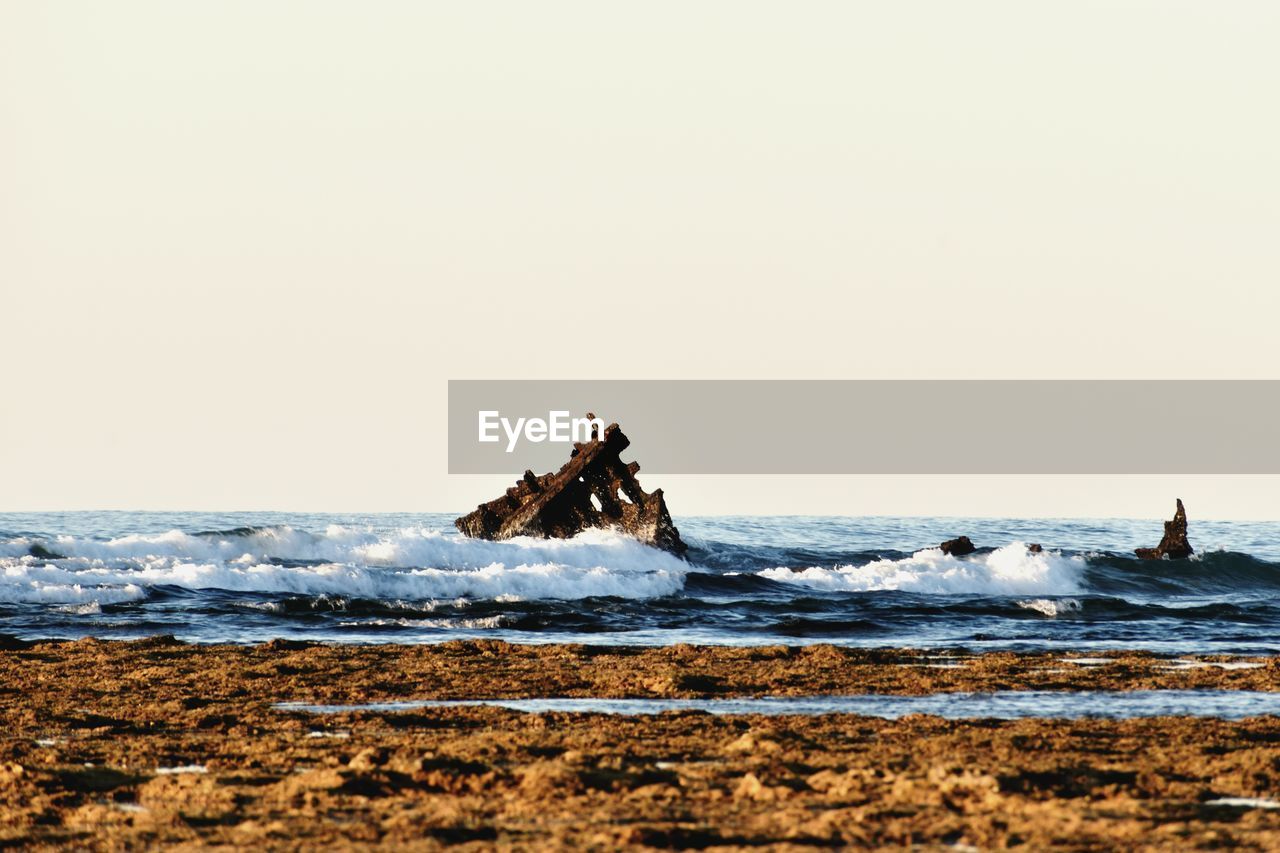 Scenic view of a ship wreck against clear sky