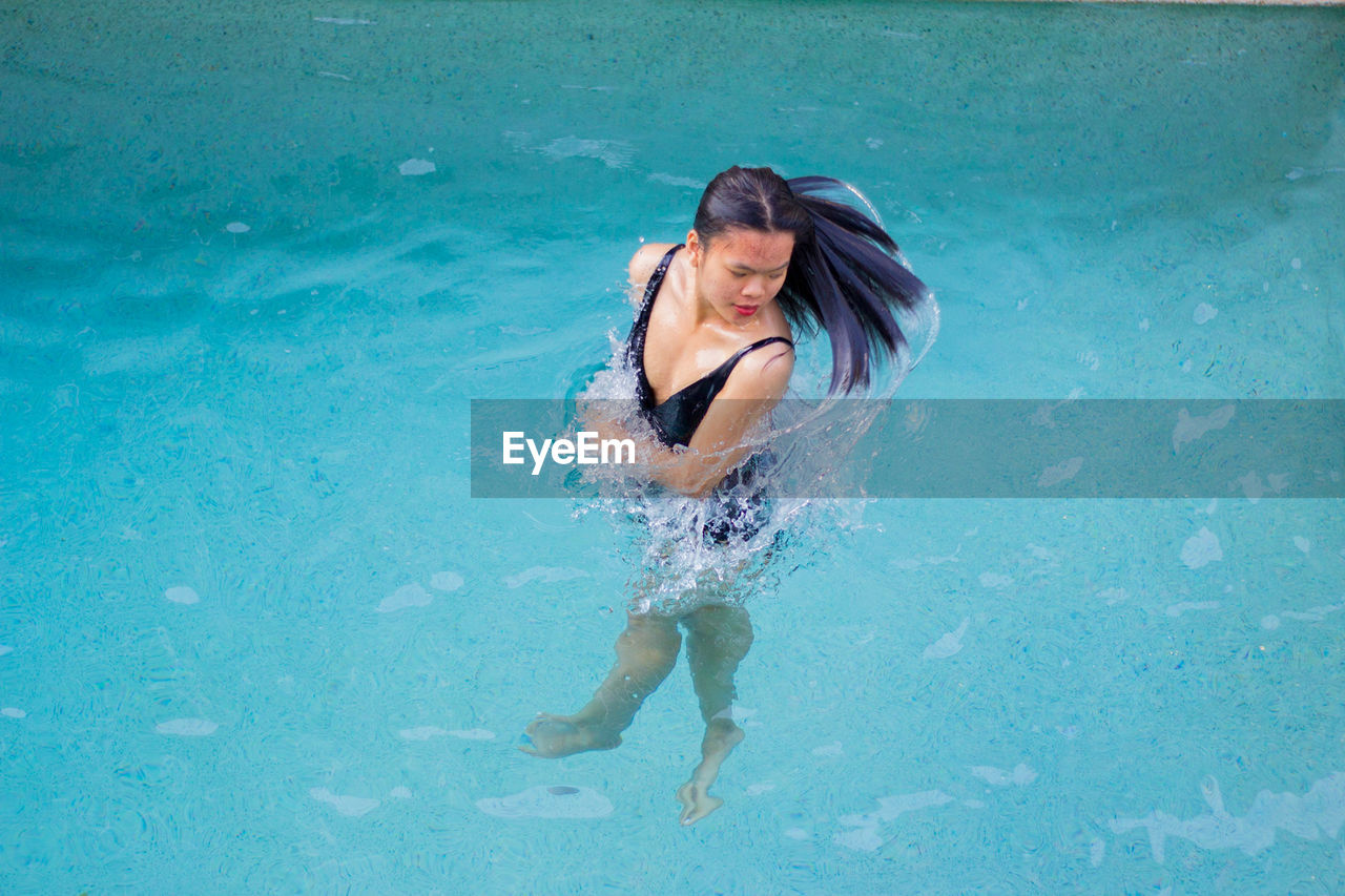 Beautiful asian young woman in the water