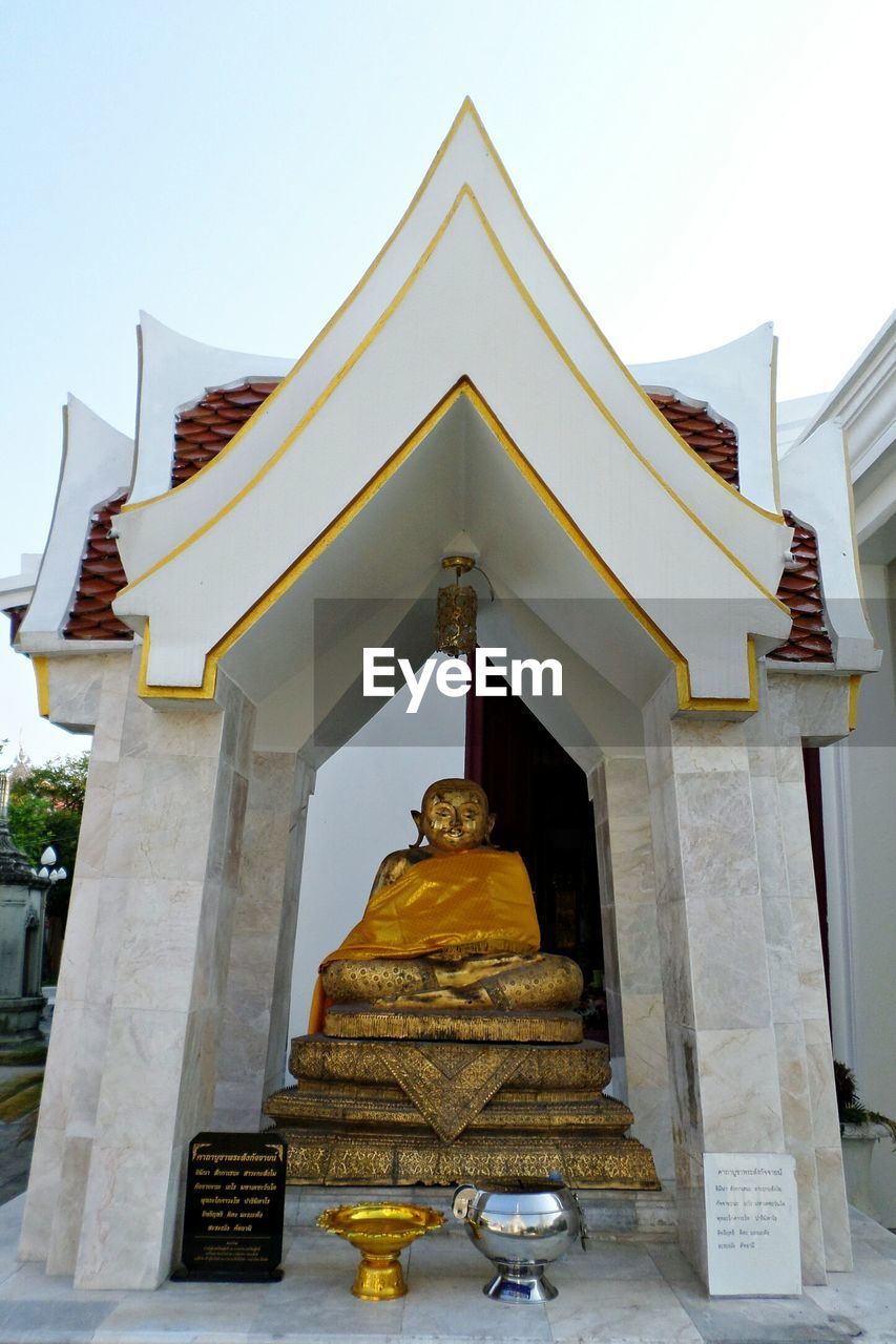 LOW ANGLE VIEW OF BUDDHA STATUE AGAINST CLEAR SKY