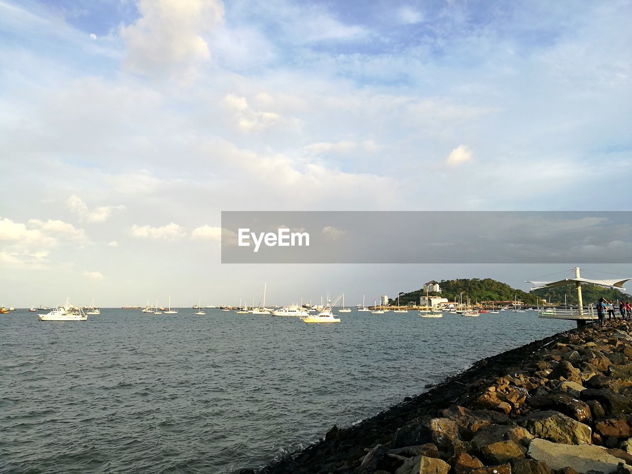 Sailboats in sea against sky