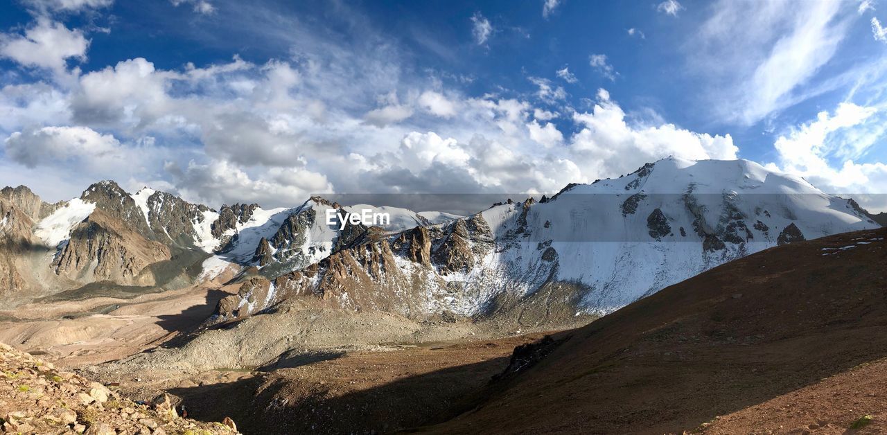 Panoramic view of snowcapped mountains against sky