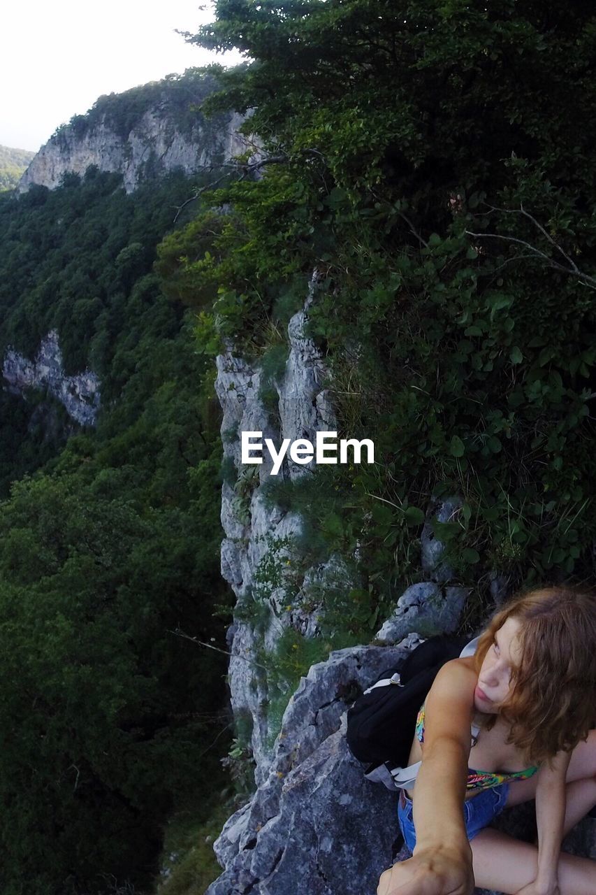 SCENIC VIEW OF WATERFALL WITH MOUNTAINS IN BACKGROUND