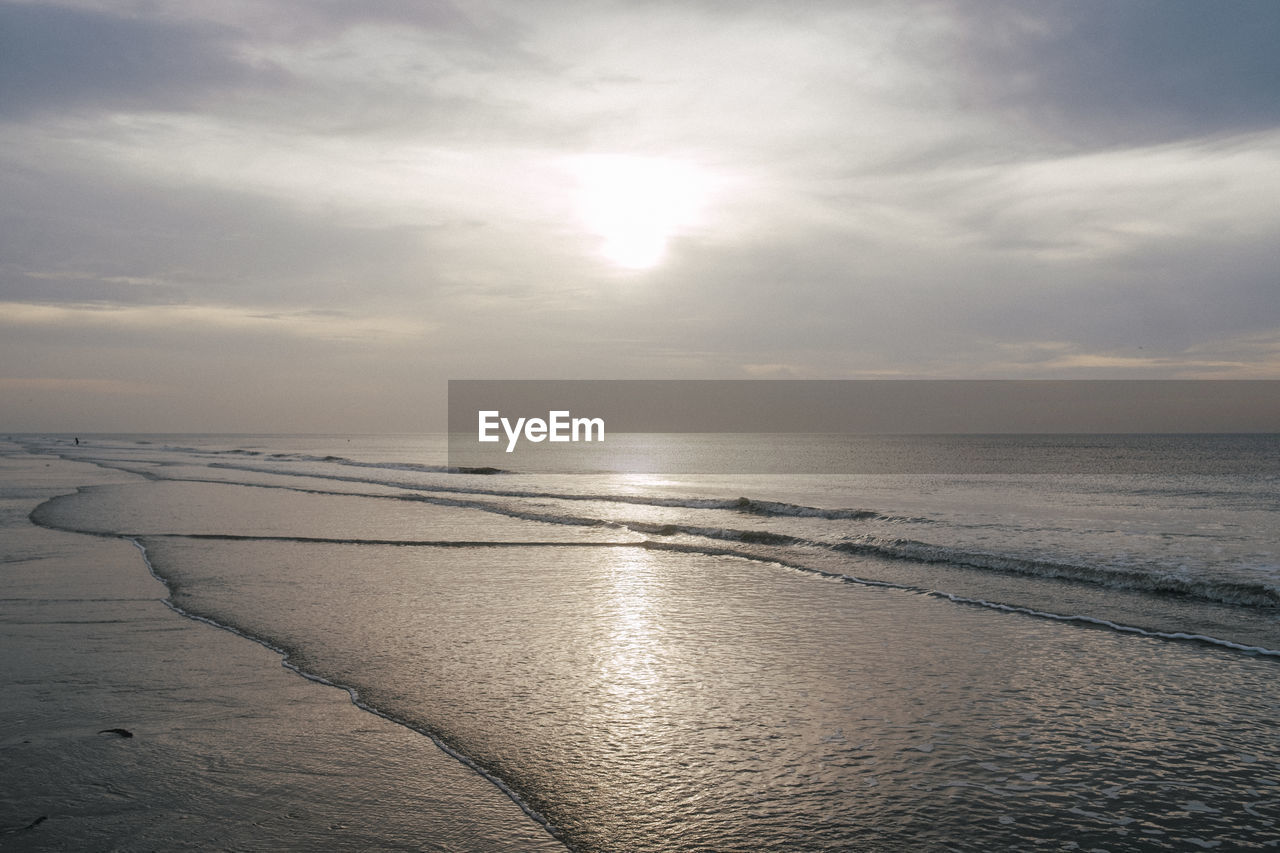 sky, water, sea, horizon, beauty in nature, scenics - nature, sunlight, cloud, tranquility, nature, beach, land, horizon over water, tranquil scene, ocean, reflection, sun, wave, sunset, sand, no people, idyllic, shore, outdoors, environment, sunbeam, dawn, body of water, day, coast, seascape, wind wave, dramatic sky, light, travel, landscape