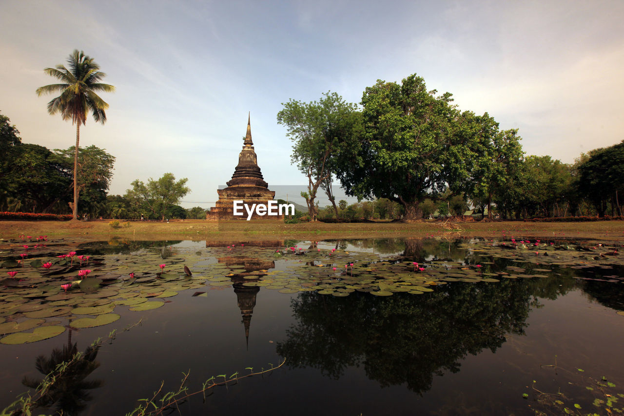 REFLECTION OF TREES AND BUILDINGS IN LAKE