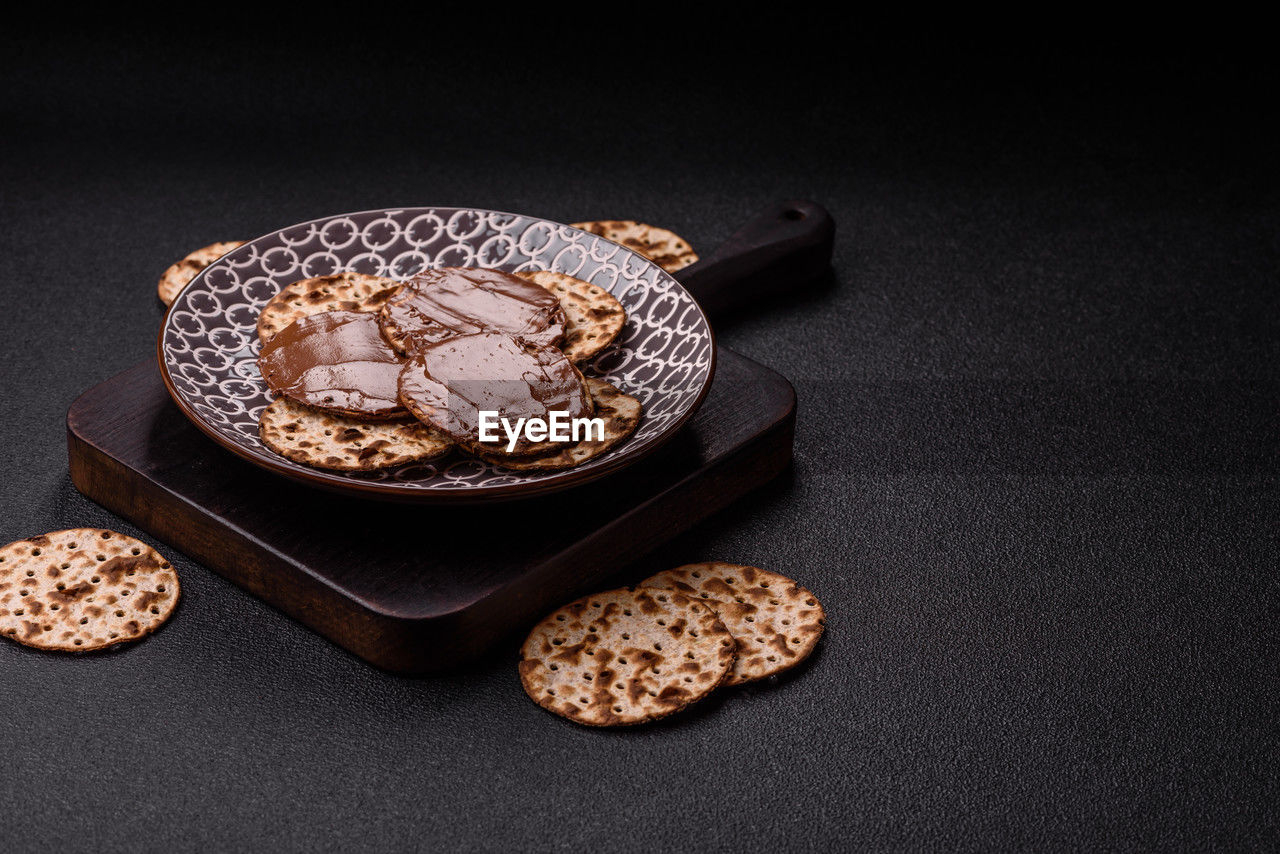 food and drink, food, baked, studio shot, sweet food, indoors, sweet, chocolate, dessert, freshness, no people, jewellery, black background, cake, still life, copy space, healthy eating, high angle view