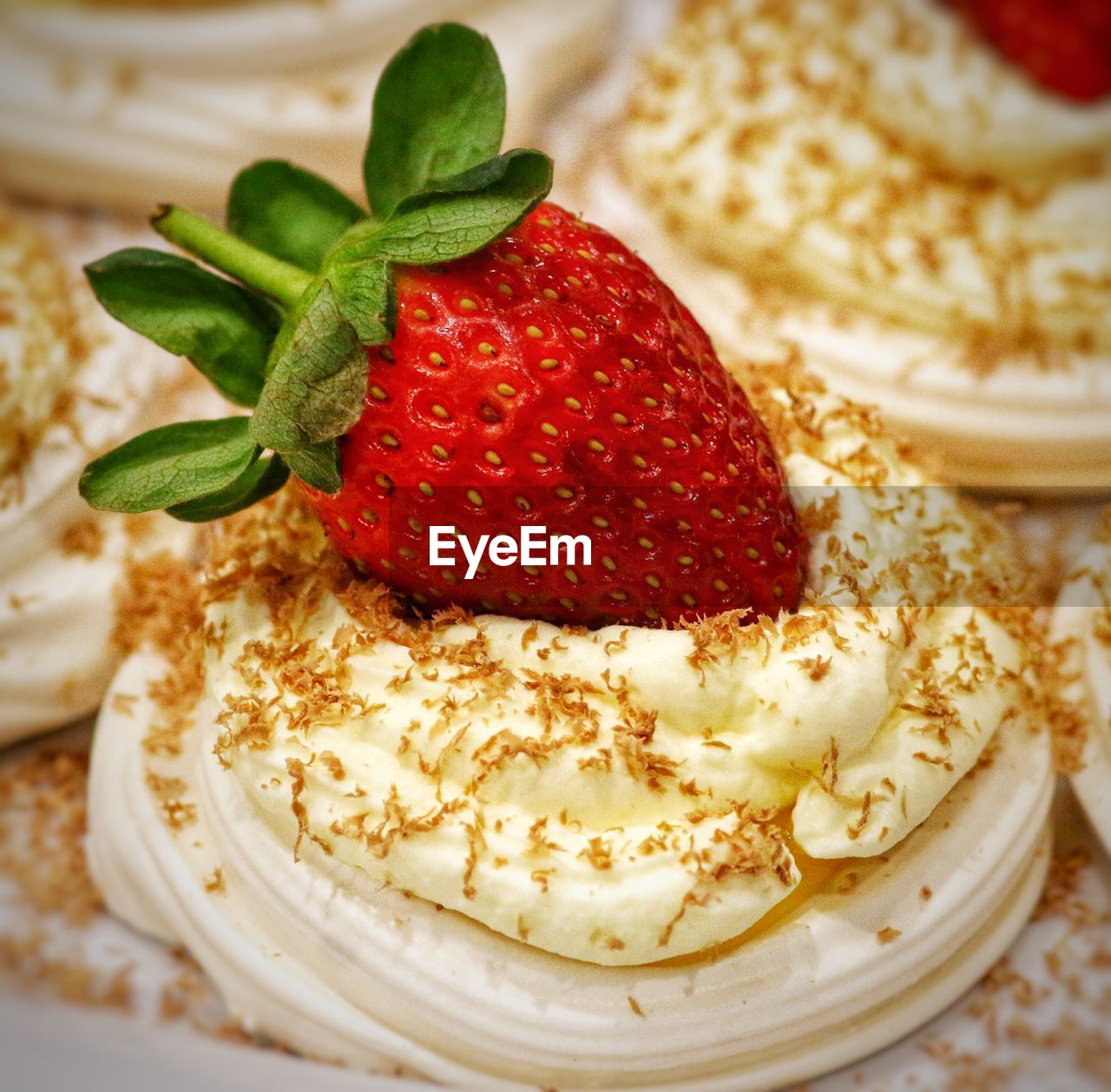 Close-up of strawberry on whipped cream
