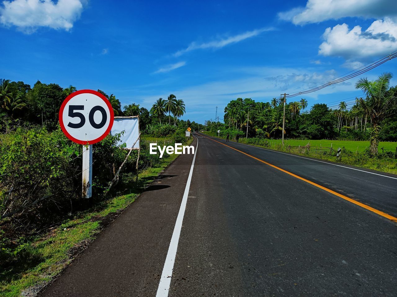 Road sign against sky