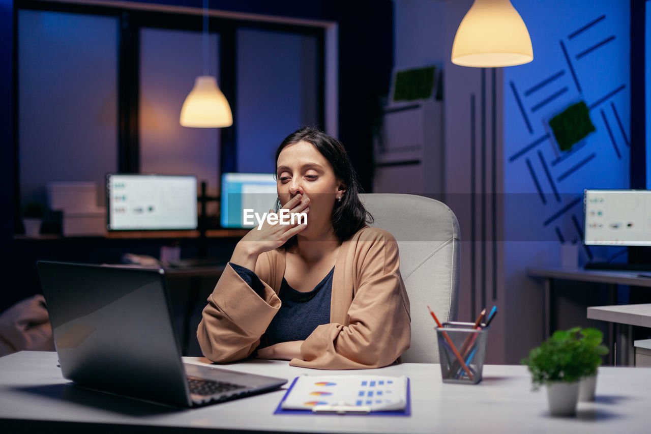 Tired businesswoman working in office