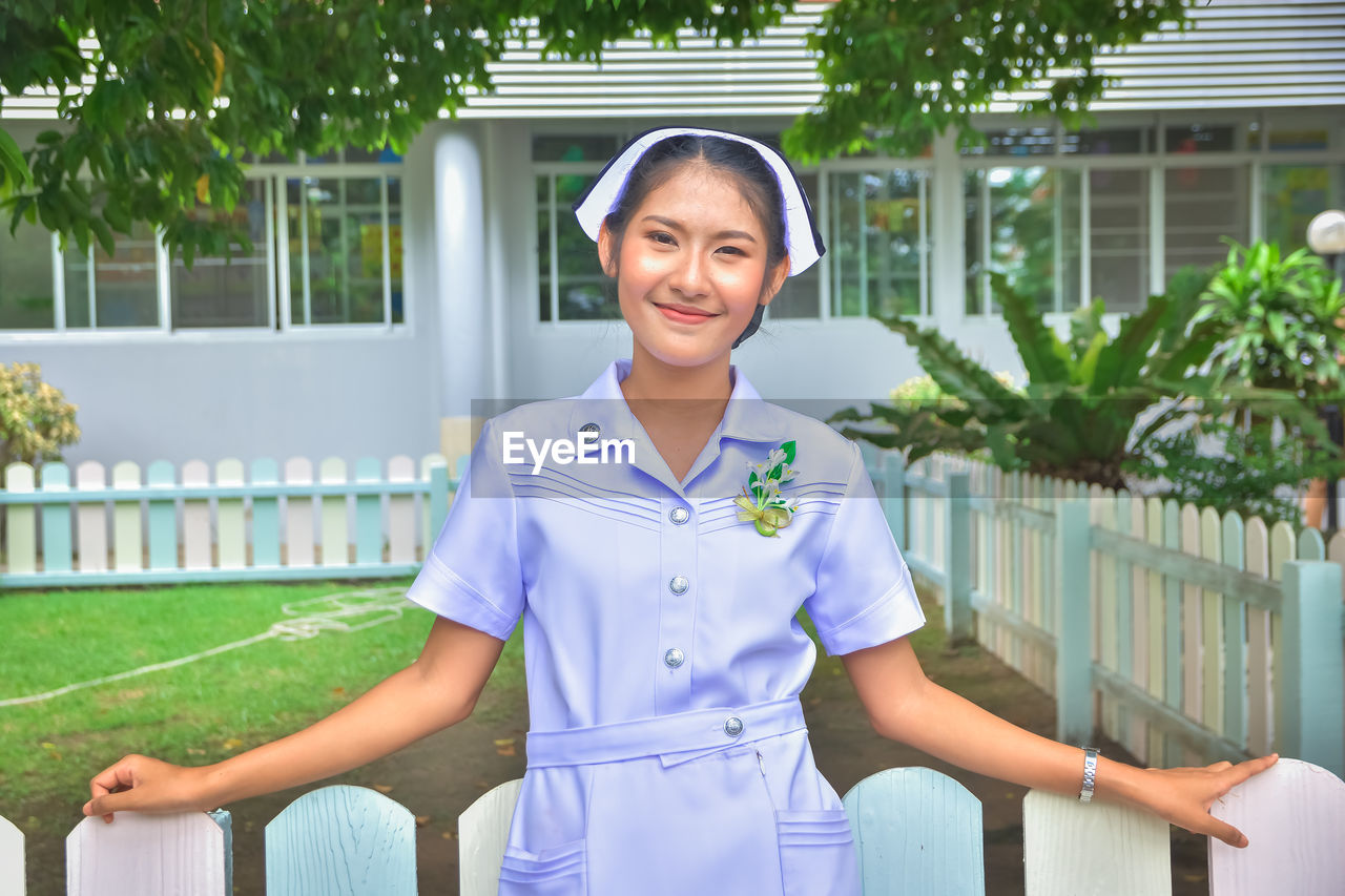 Smiling young nurse on field