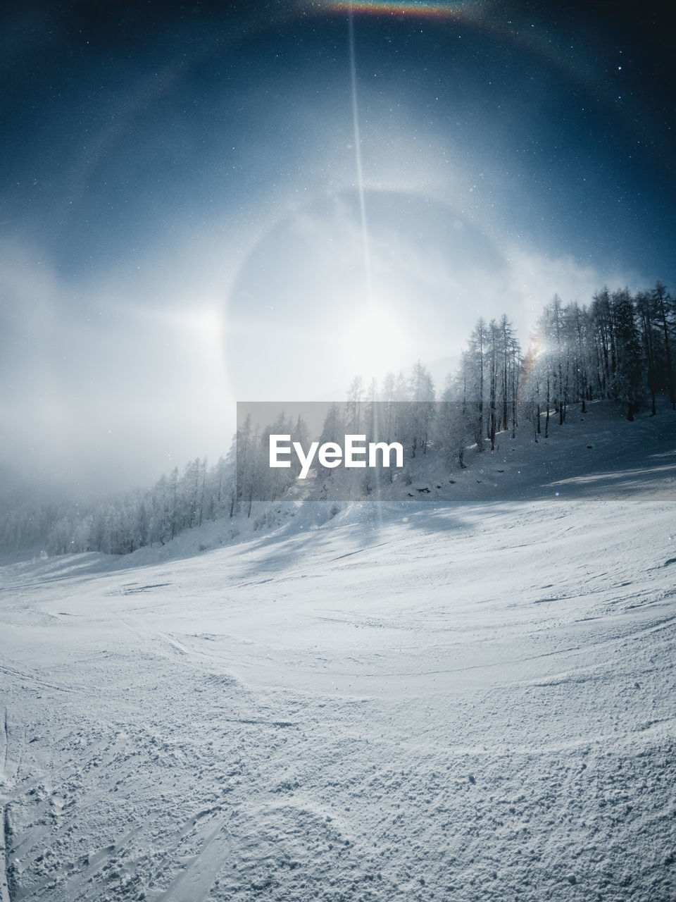 Sun halo on a cold winter day in the zauchensee ski resort, austria.