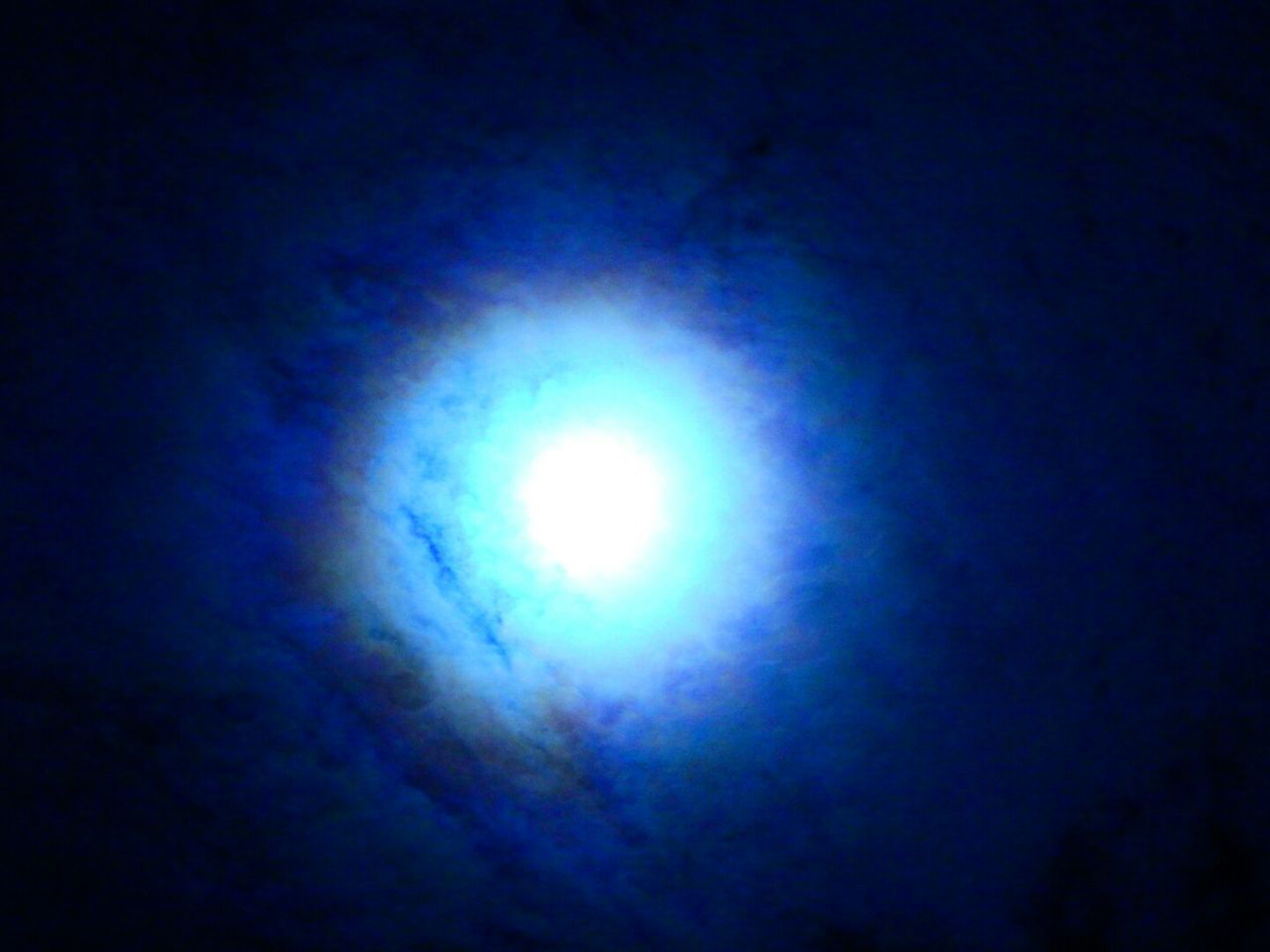LOW ANGLE VIEW OF ILLUMINATED BLUE SKY