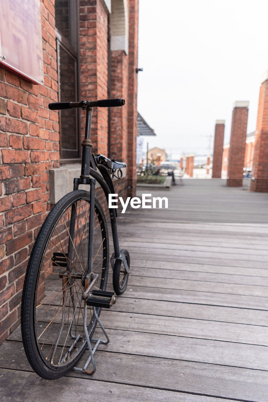 Bicycle on footpath against building