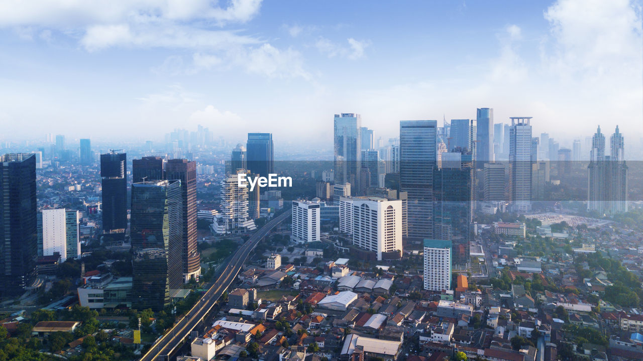 High angle view of modern buildings in city against sky