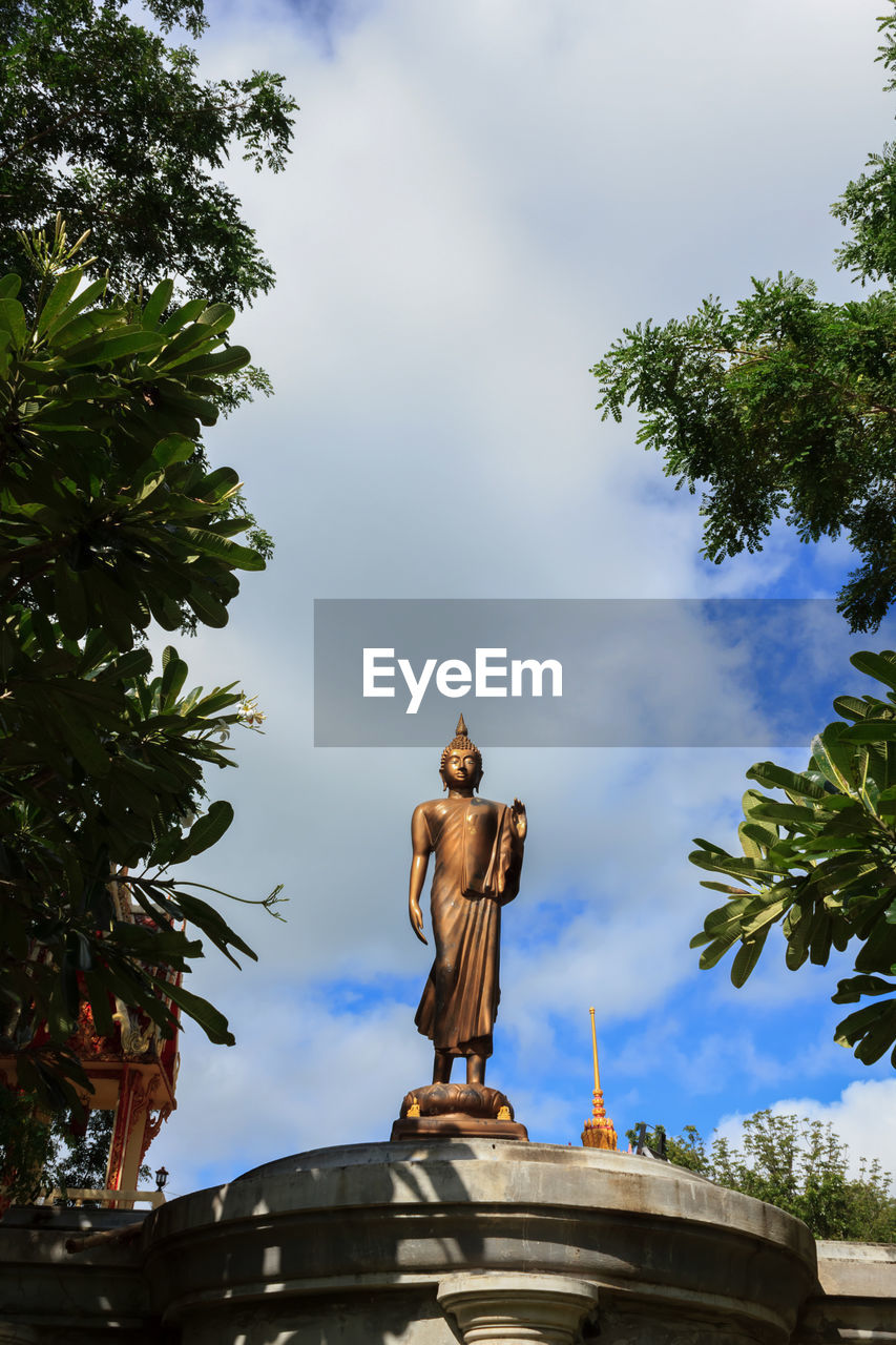 LOW ANGLE VIEW OF BUDDHA STATUE AGAINST SKY