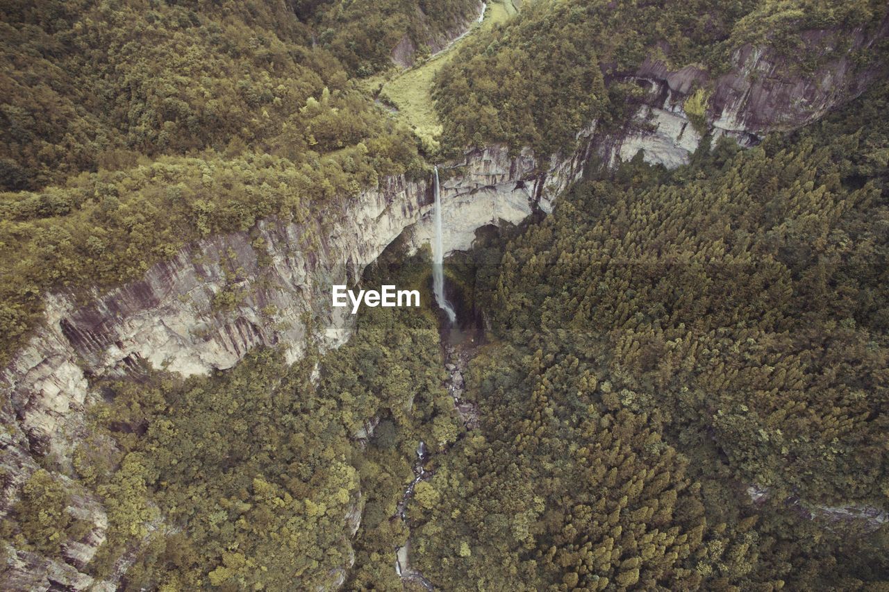 HIGH ANGLE VIEW OF WATERFALL ON RIVER