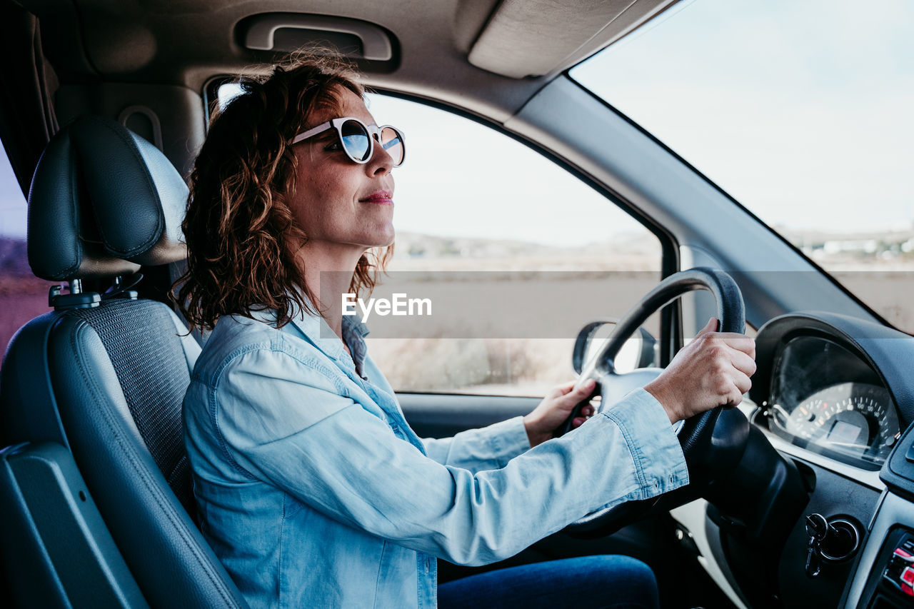 MIDSECTION OF WOMAN IN CAR