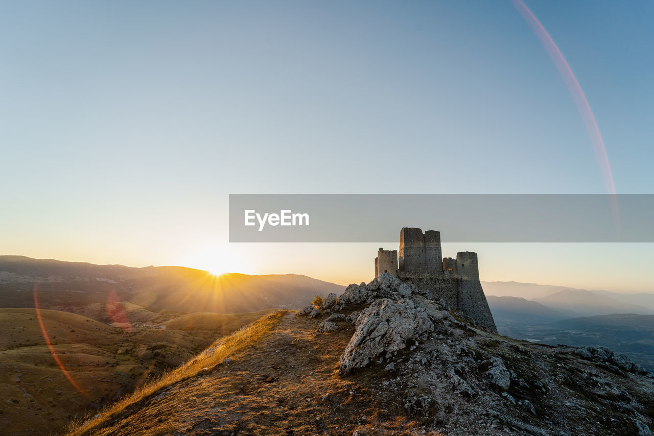 SCENIC VIEW OF MOUNTAIN AGAINST SKY AT SUNSET