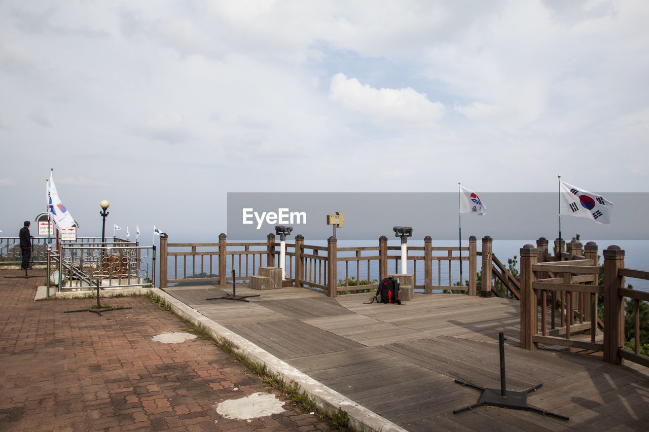 South korean flag on wooden railing at observation point