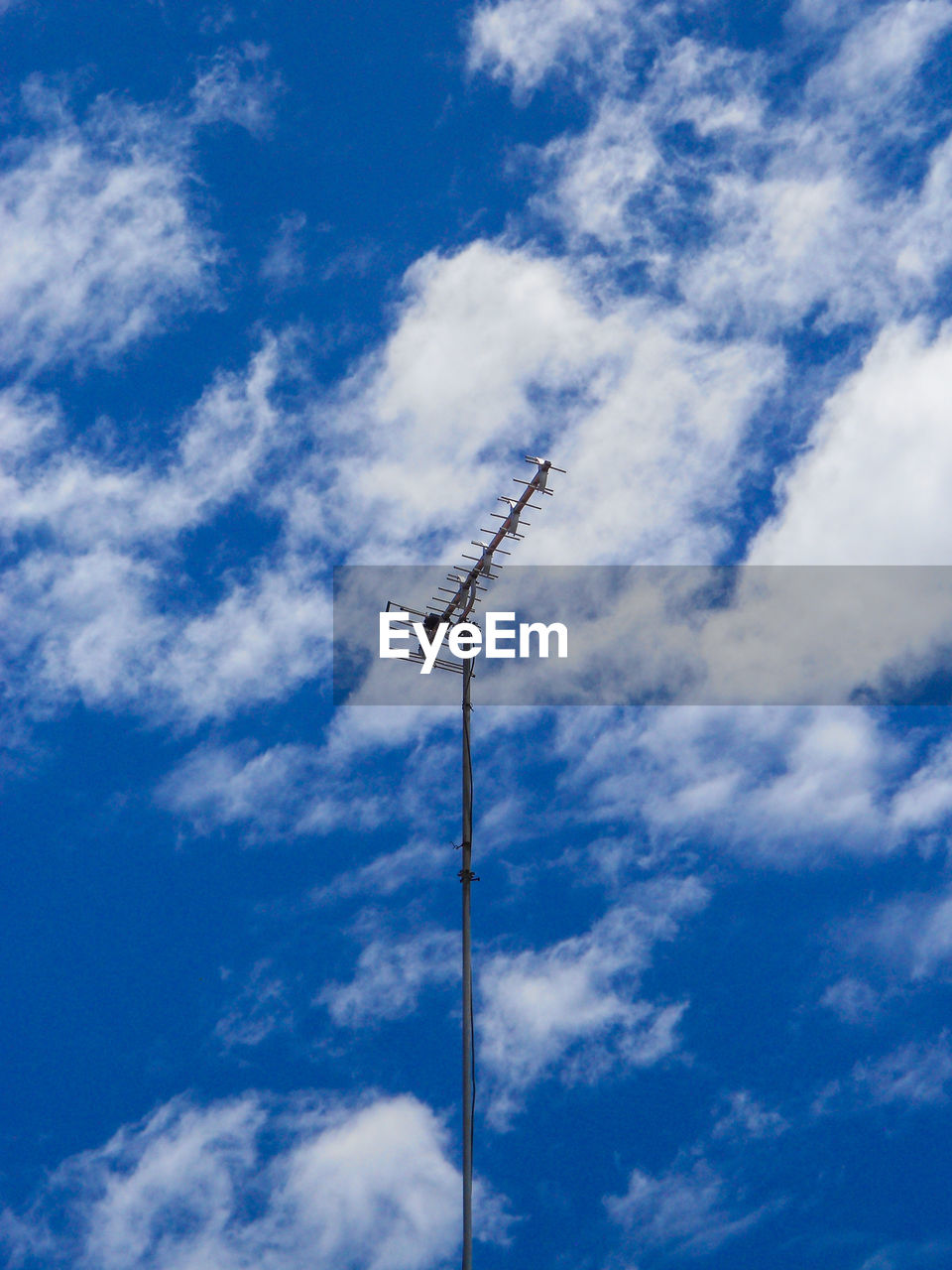 LOW ANGLE VIEW OF TELEPHONE POLE AGAINST BLUE SKY