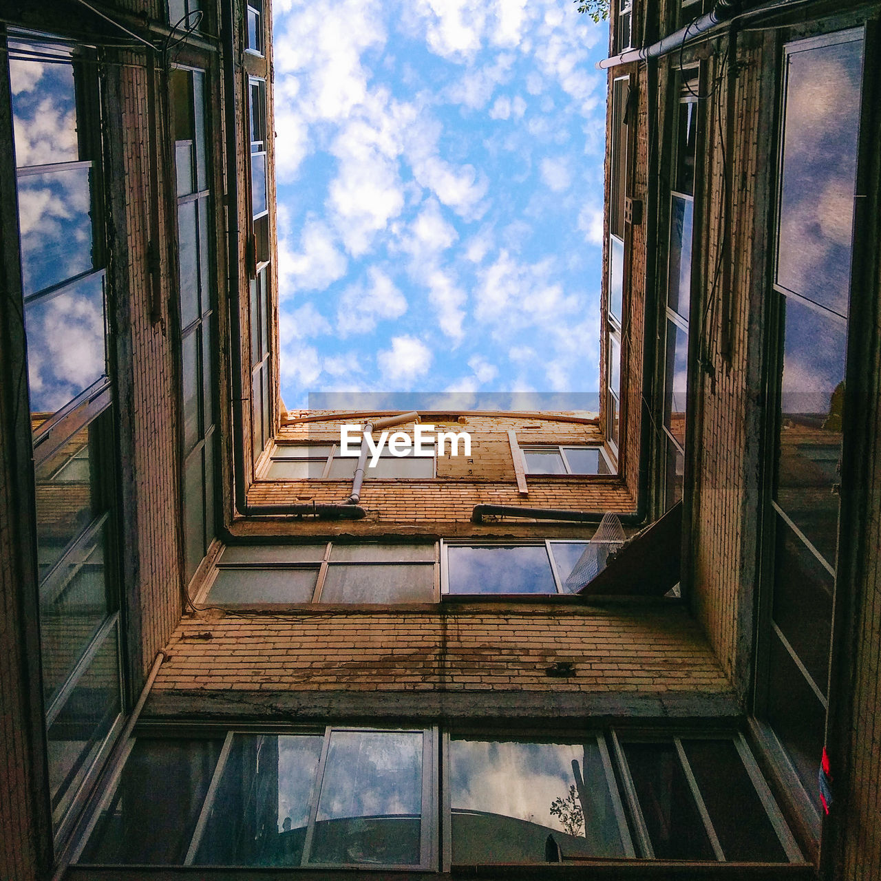 Low angle view of building against cloudy sky