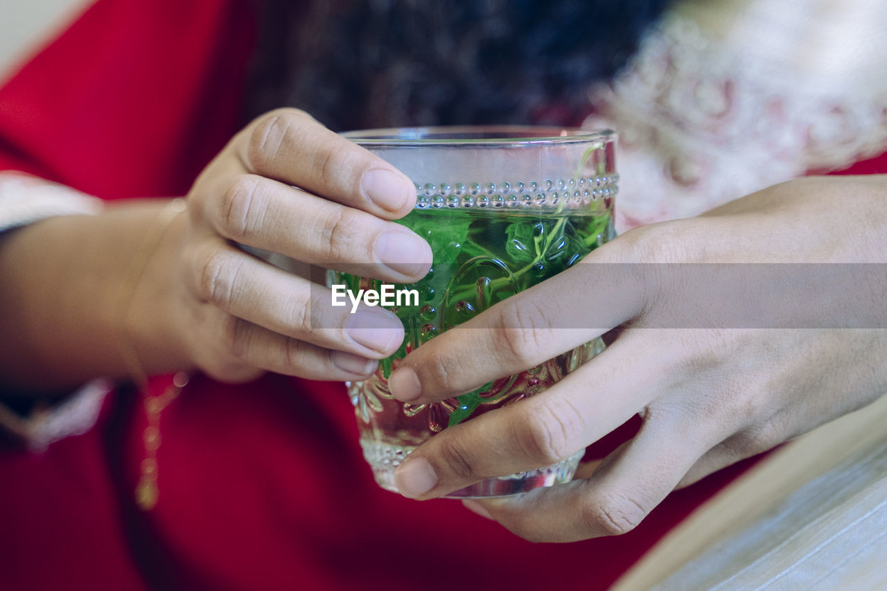 Close-up of woman holding drink