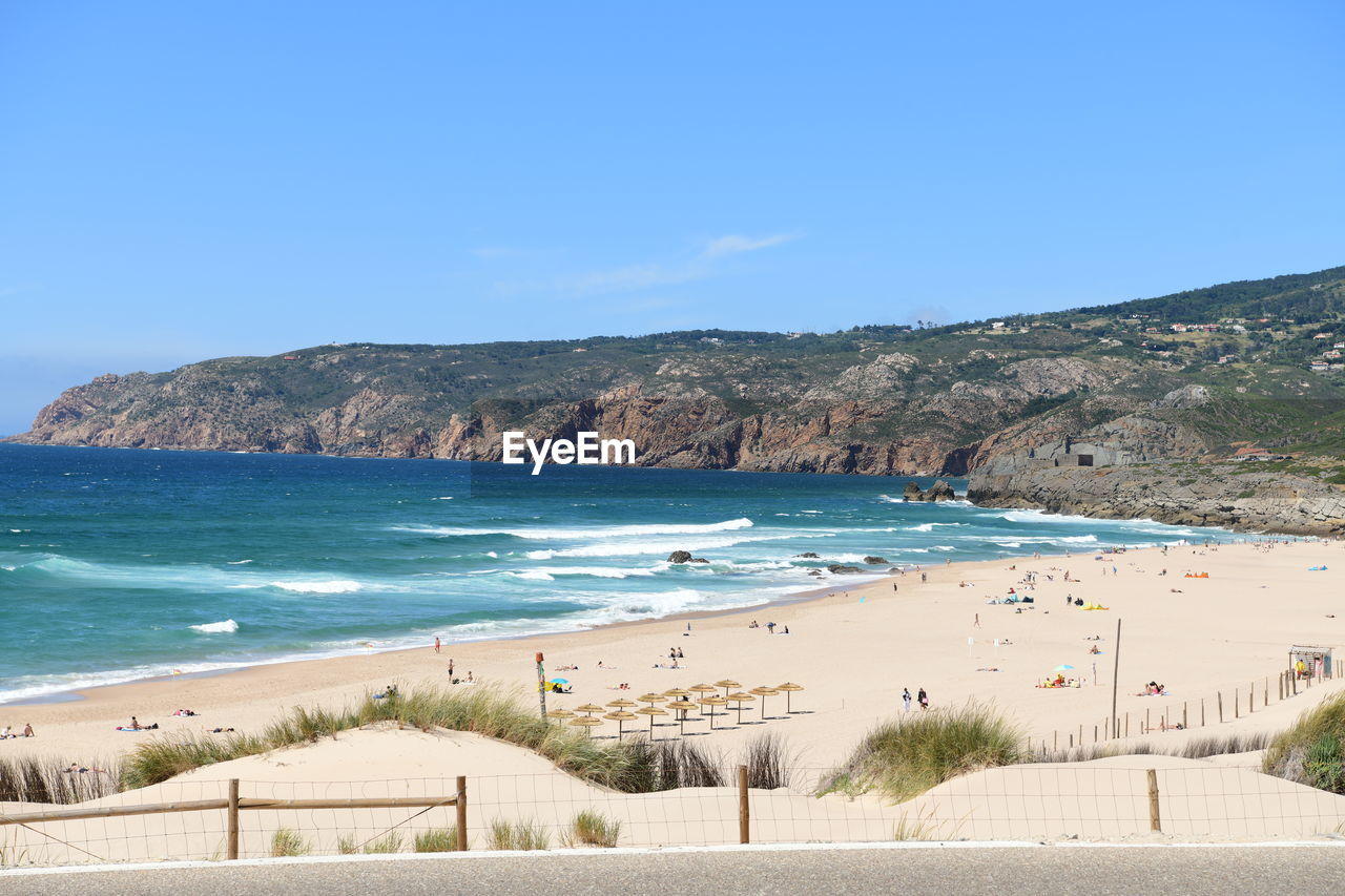 panoramic view of beach against clear blue sky