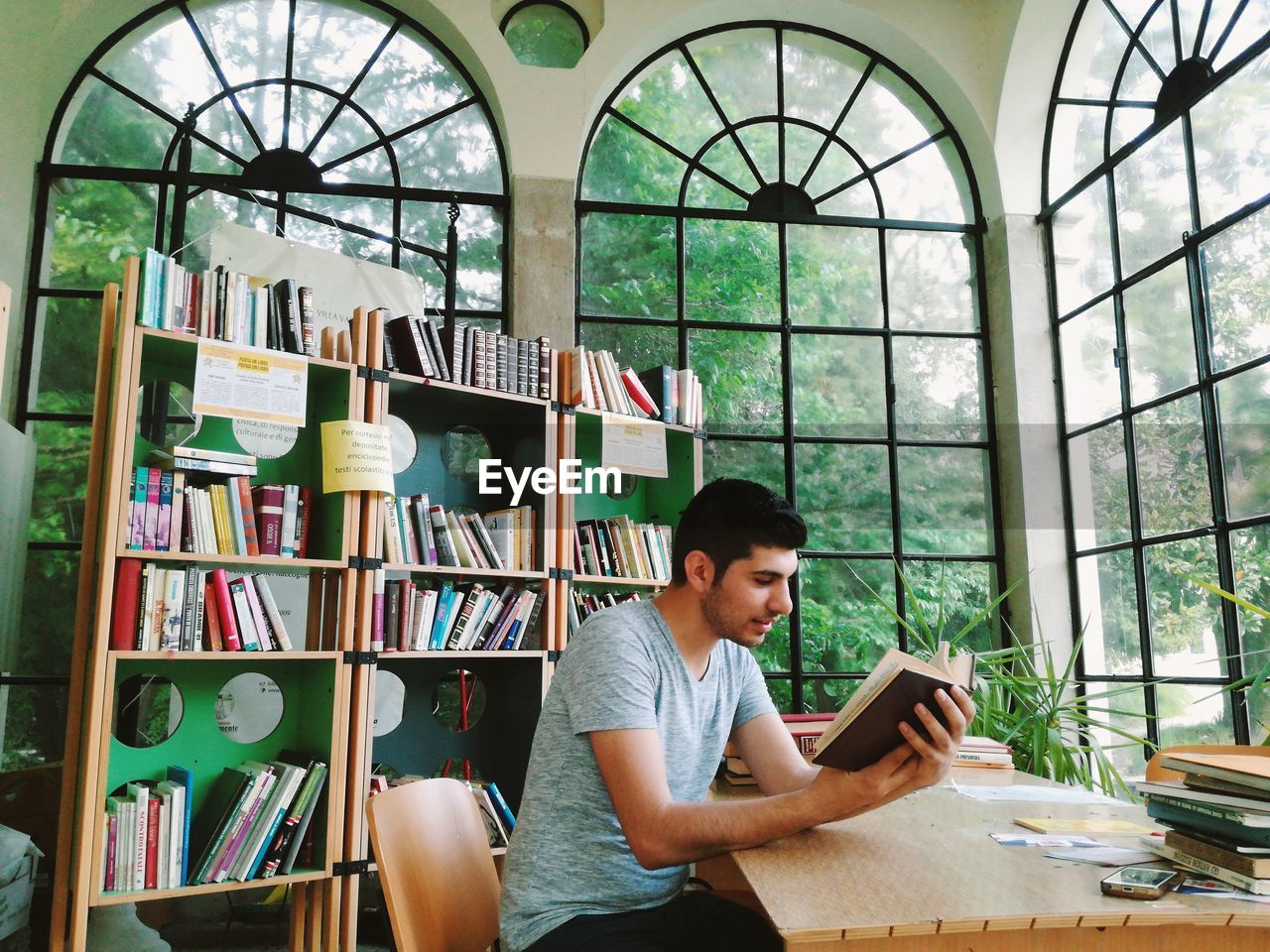 Man reading book at library