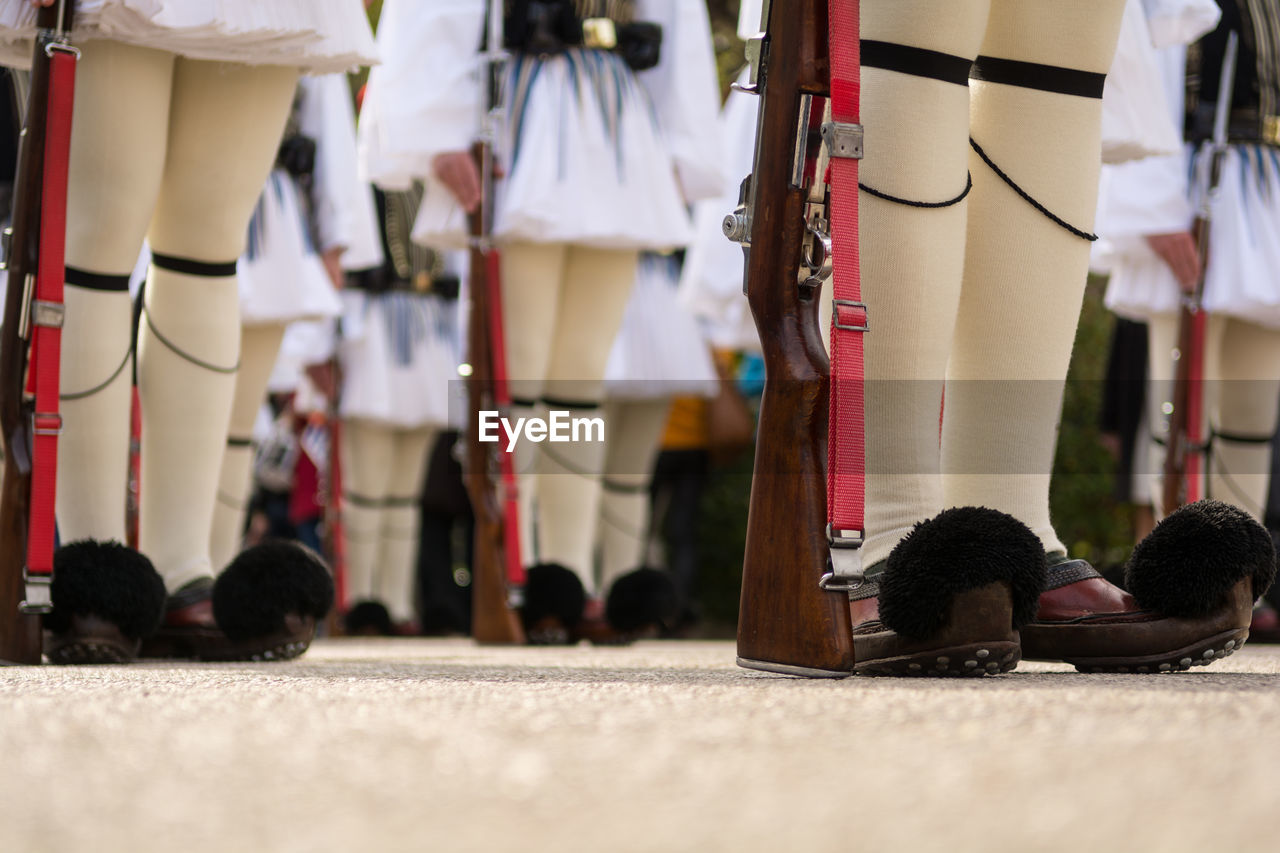 Low section of soldiers holding rifles during honor guard