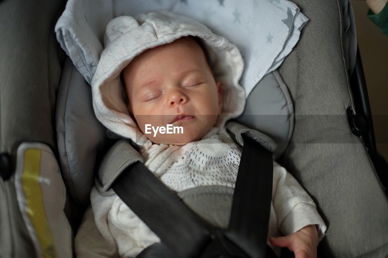 Portrait of newborn baby girl in baby stroller
