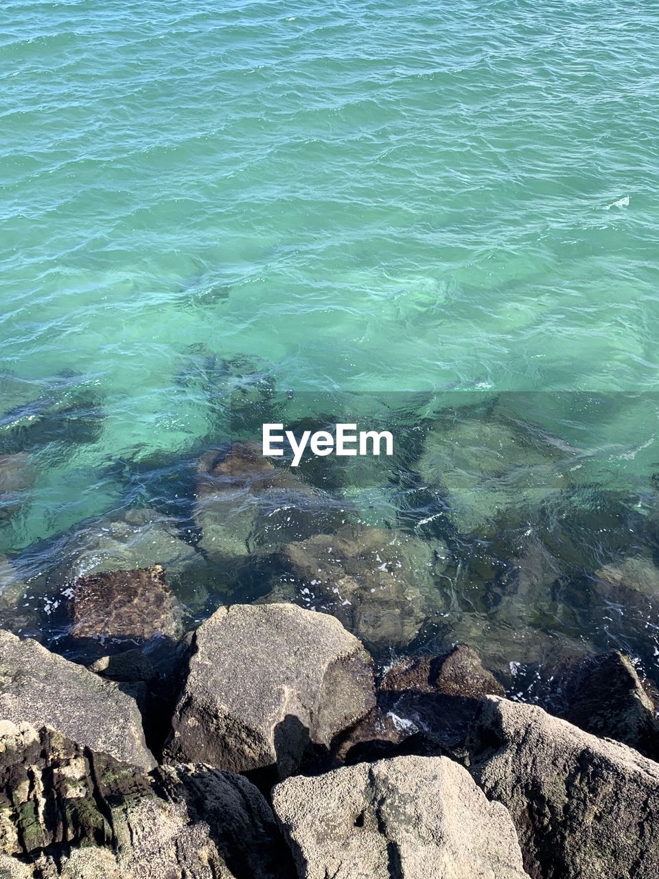 water, nature, day, high angle view, sea, rock, no people, beauty in nature, sunlight, outdoors, scenics - nature, transparent, tranquility, motion, backgrounds, turquoise colored, full frame