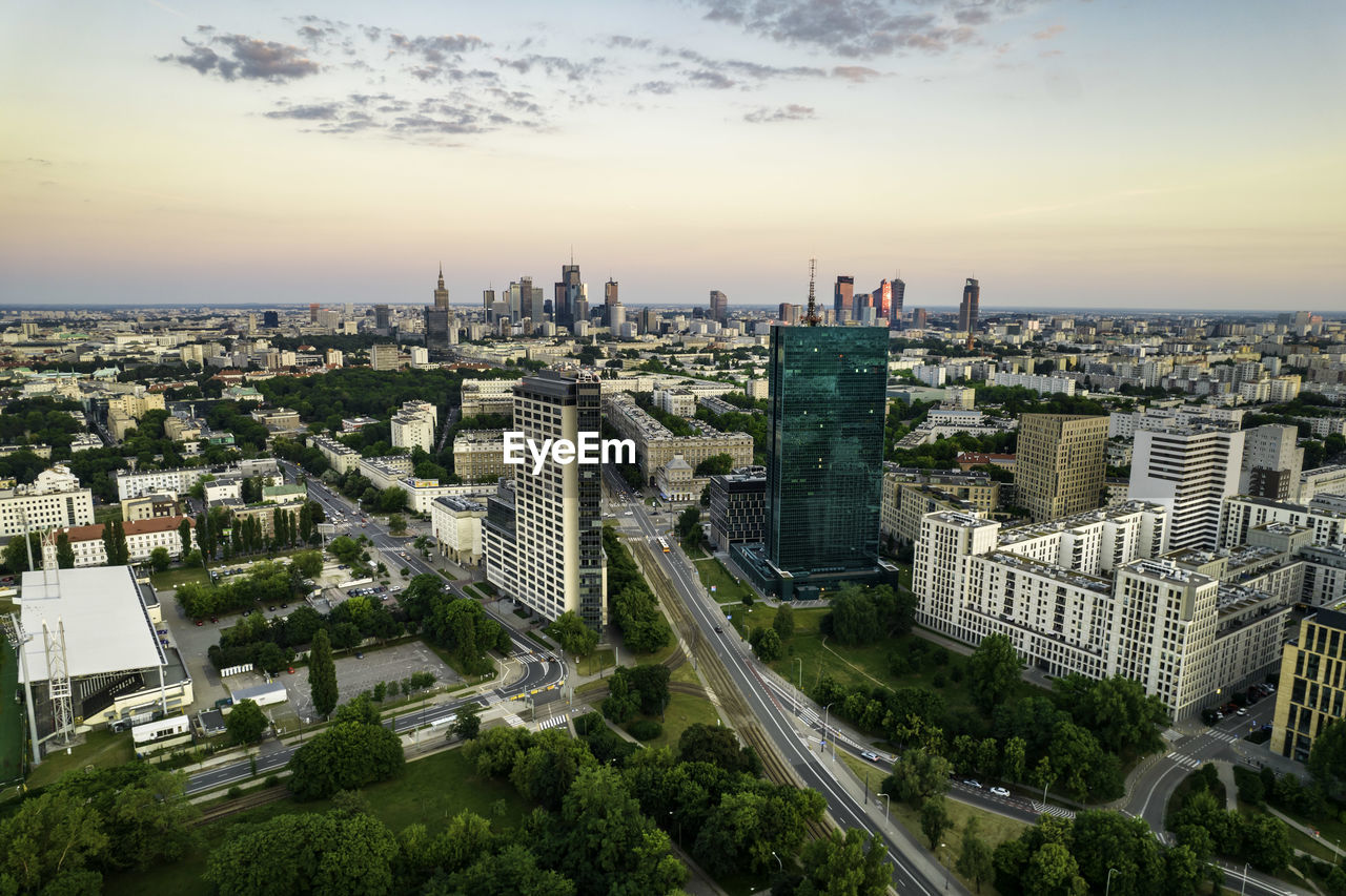 Warsaw, city centre panorama at sunset, business centre 2022. sunset reflected in buildings.