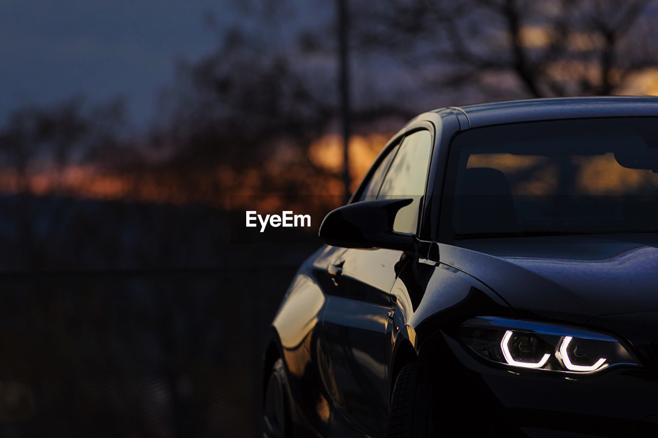 VIEW OF CAR AT SUNSET