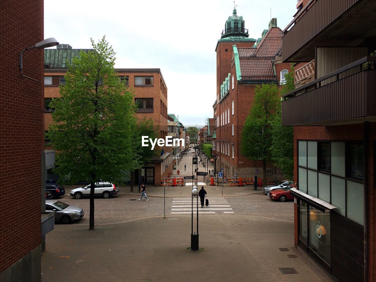 CARS ON ROAD AGAINST BUILDINGS