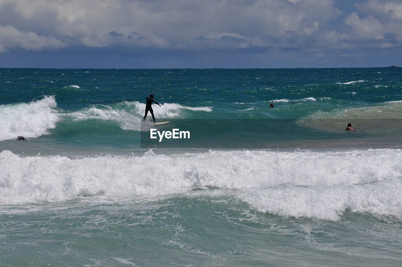 Surfers in the turquoise indian ocean waves at scarborough beach in western australia