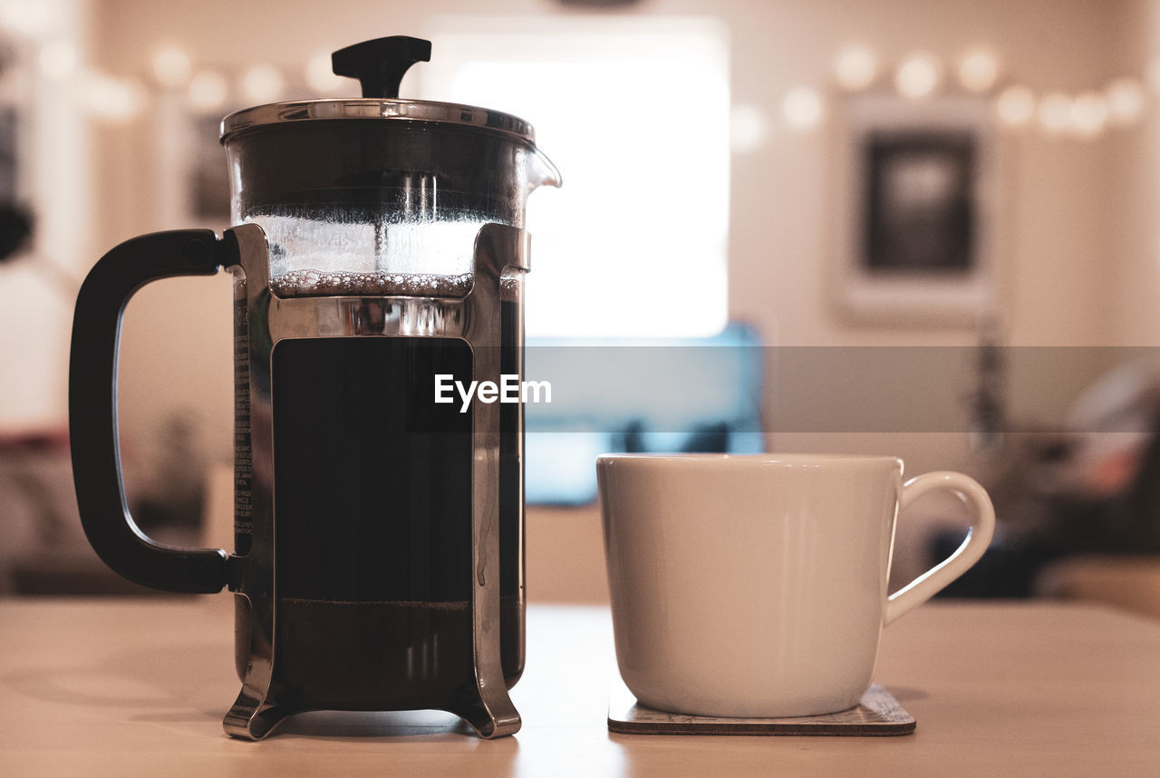 Close-up of coffee cup on table at home