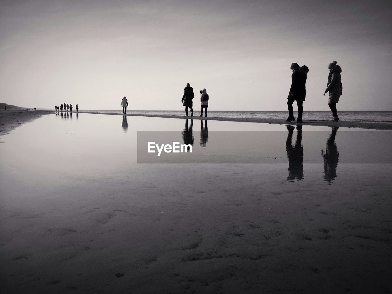 Group of people walking on beach