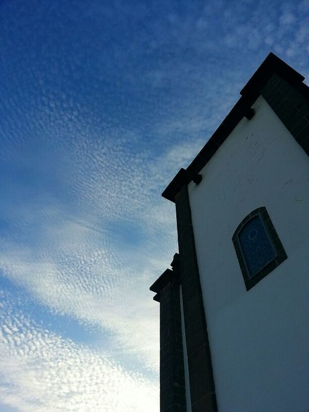 LOW ANGLE VIEW OF BUILT STRUCTURES AGAINST BLUE SKY