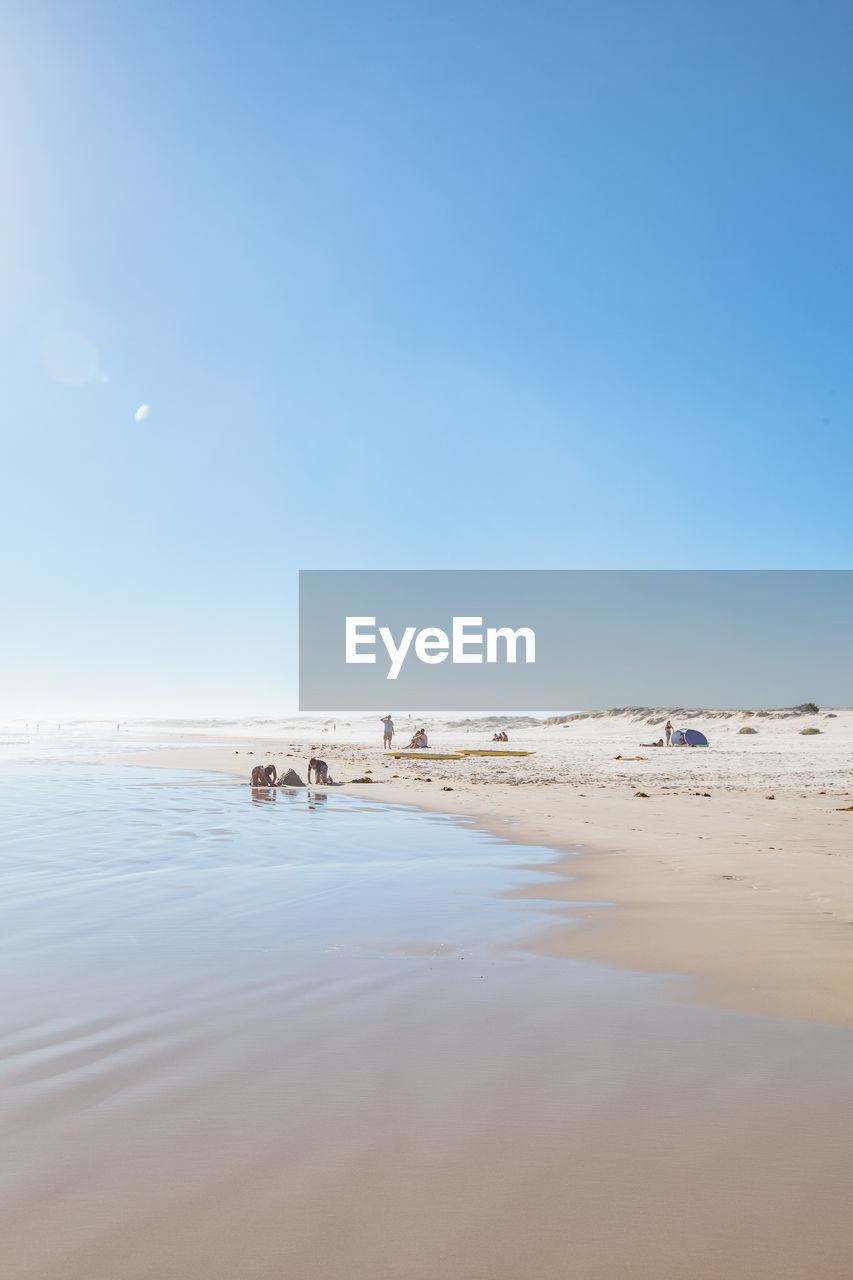 Scenic view of beach against blue sky