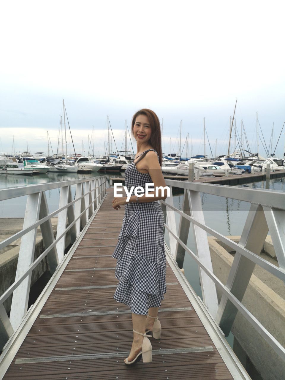 Portrait of smiling woman standing at harbor