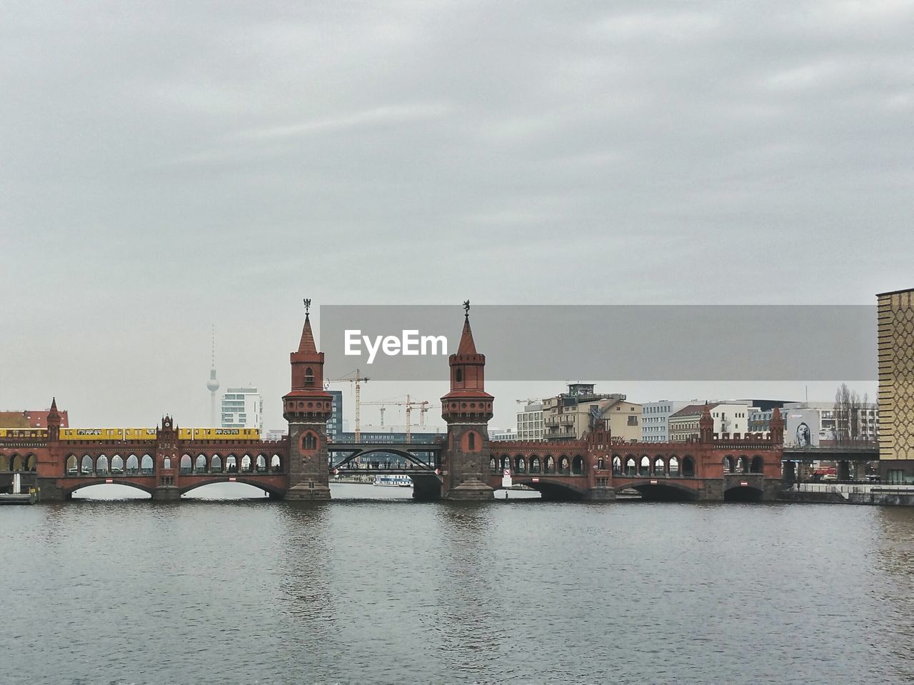 View of cityscape against cloudy sky