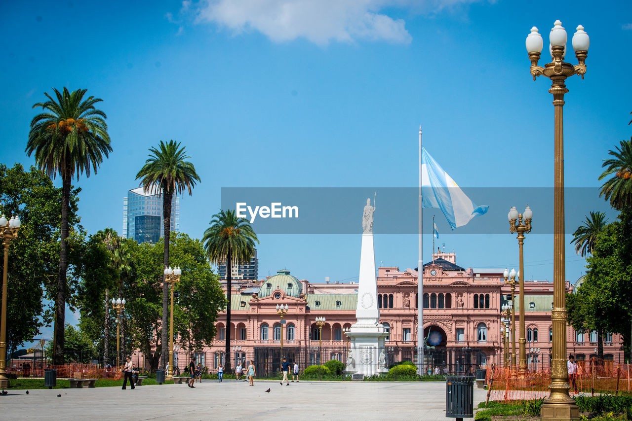 PALM TREES AND BUILDINGS AGAINST SKY