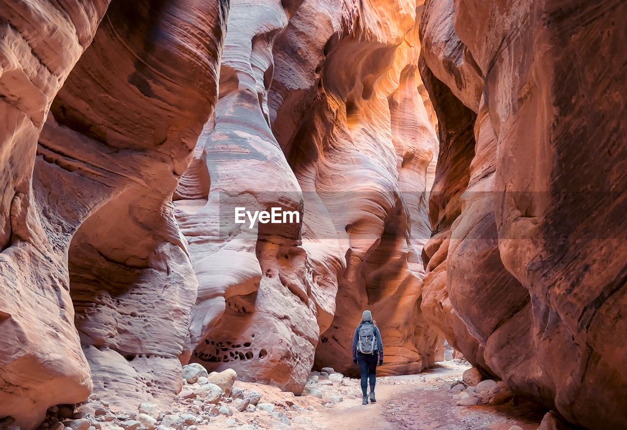 low angle view of man standing on rock formations