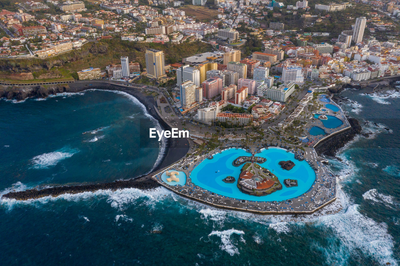 Swimmingpool lago martiánez in puerto de la cruz drone view at stormy weather.