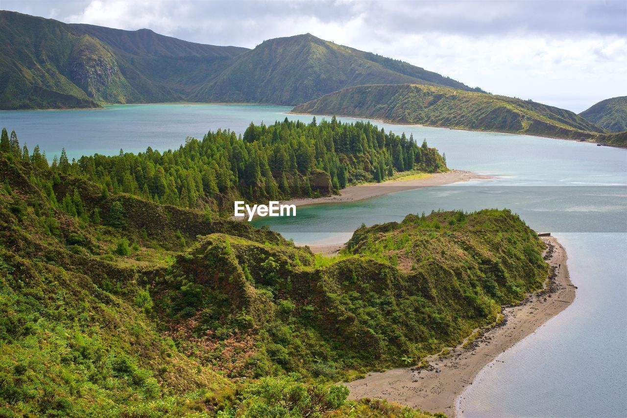 Scenic view of sea and mountains against sky