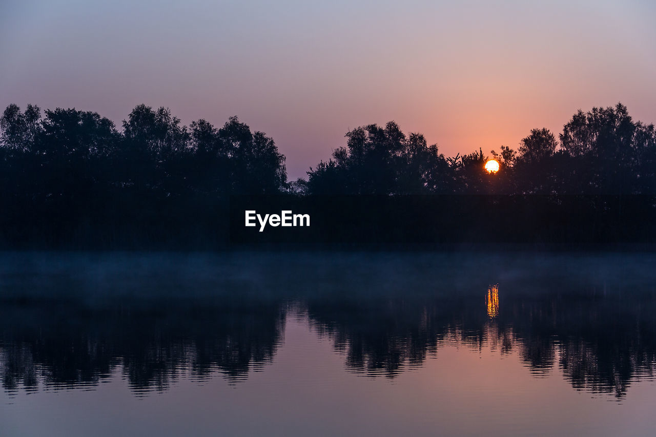 Scenic view of lake at sunset